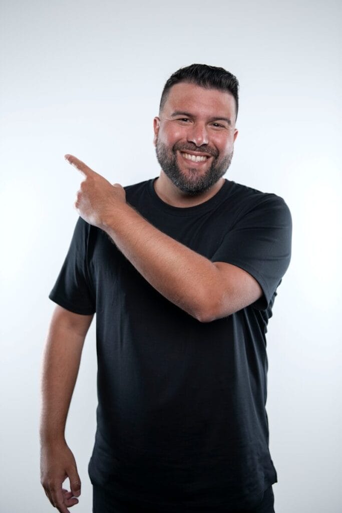 A man with a beard pointing at something