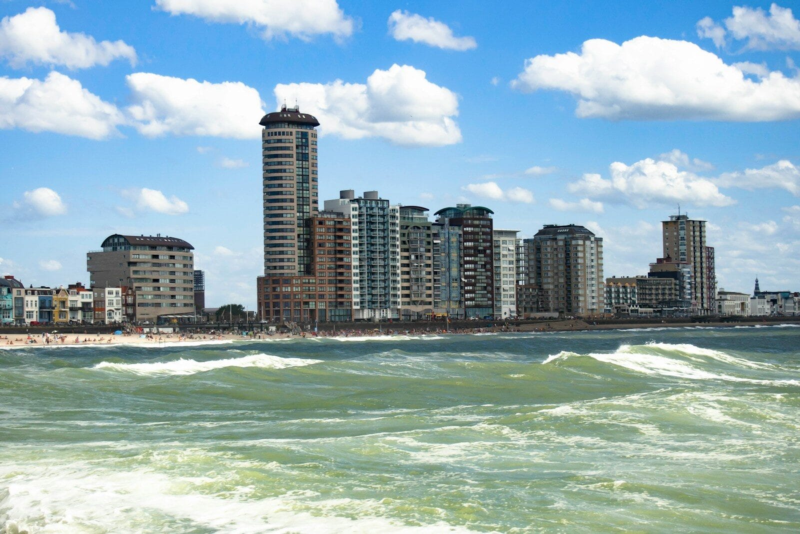 high rise buildings near sea under blue sky during daytime